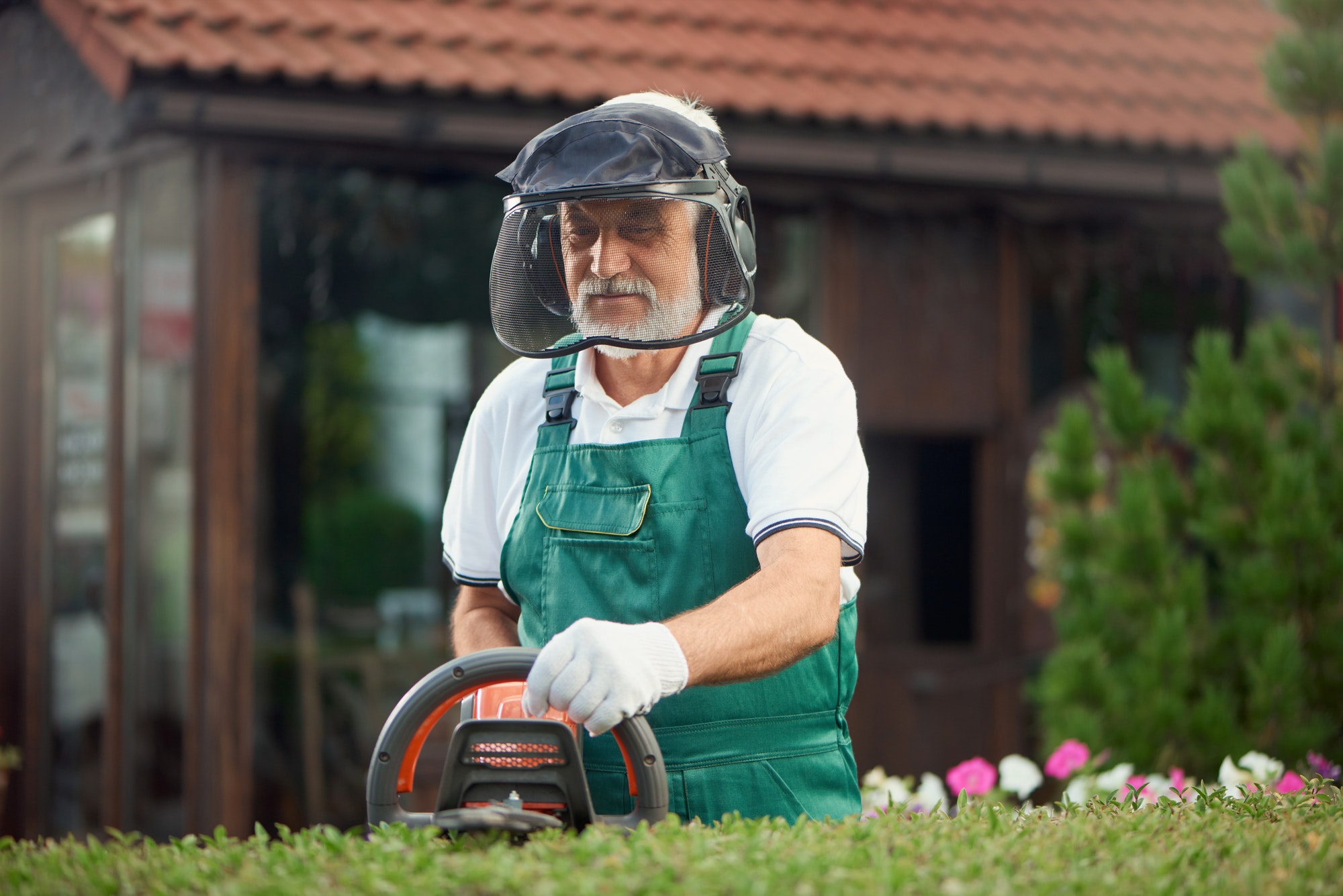 Gardener wearing protection using trimming machine